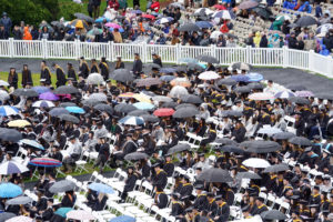 Umbrellas shielded graduates and their guests from drizzly weather throughout the ceremony. Photo by Suzanne Carr Rossi.