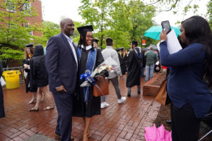 2022 graduate Madison Williams and her dad, John Williams, take their photo on Campus Walk after UMW's Commencement ceremony. Photo by Suzanne Carr Rossi. 