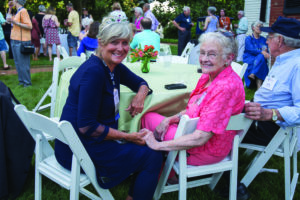 Sally Kelly '68 visits with 1950 graduates Marcy and Juney Morris at Reunion Weekend in 2019.