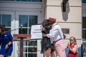 UMW Board of Visitors Rector Heather Crislip '95 hugs Rucker after making her remarks. Edward John Photography.