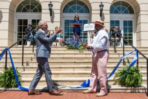 UMW President Troy Paino congratulates Rucker after the two conducted the ceremonial ribbon cutting. Edward John Photography.