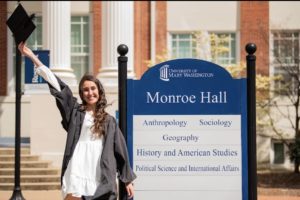 Kramer poses in front of UMW's Monroe Hall before graduation in May.