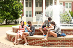 Alums and their families enjoyed Mary Washington pastimes like hanging out by the fountain and bench sitting throughout the weekend. Photo by Karen Pearlman.