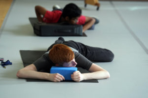 High-schooler Foster Barber participates in the Breathe and Flow exercise session, one of several enrichment activities. Photo by Suzanne Carr Rossi.