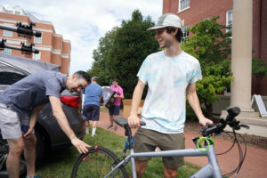 Benjamin Hamlett of Richmond, right, gets some bike help from dad Watt Hamlett on Ball Circle. Photo by Suzanne Carr Rossi.