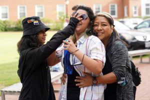 Alex Pineda-Bautista, center, gets a hug from mom Sandra Bautista as Shroom Pineda-Bautista adds some younger-sibling energy. Photo by Suzanne Carr Rossi.