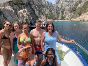 UMW students Madeline Ice, Rose McMullen, Maggie Hatton, Nell Hatton, JD Rutledge and Celide Verna, along with Professor of Modern Languages and Literatures Brooke DiLauro, in the Mediterranean fishing port of Cassis, France. Photo courtesy of Brooke DiLauro.