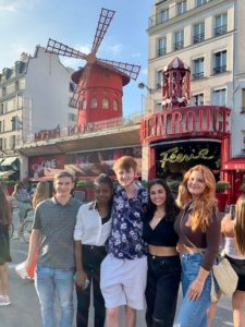 UMW students JD Rutledge, Celide Verna, Trey Reid, Maggie Hatton and Nell Hatton pose in in front of the Moulin Rouge cabaret in Paris during their 'UMW in France' travel abroad experience this summer. Photo courtesy of Brooke DiLauro.