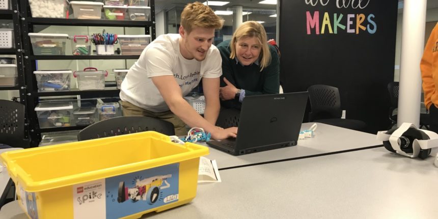 student and professor in akerspace