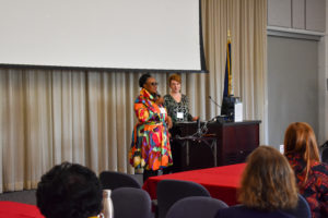 Colloquium co-chairs Kimberly Young (left) and Beth Williams address participants. Photo by Brolin Creative.