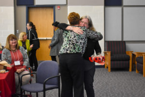 Stephanie Lyles (facing front) hugs UMW Executive Director of Human Resources Beth Williams. Lyles received this year's Patricia Lacey Metzger award, given annually at the Women's Leadership Colloquium @ UMW. Photo by Brolin Creative.