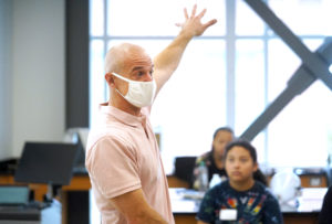 Professor of Physics Matt Fleenor uses balloons to illustrate the principles of space. Photo by Suzanne Carr Rossi.