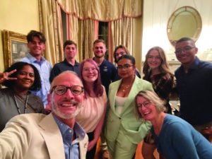 UMW President Troy Paino and wife Kelly (front) pose for a selfie during one of the regular dinners he hosts for students at his home at Brompton.