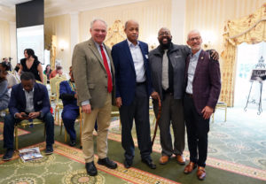 From left to right: U.S. Sen. Tim Kaine, Roland Moore, Chris Williams and UMW President Troy Paino pose for photos after the ceremony. Moore was the first Black student to desegregate Fredericksburg's James Monroe High School in 1962. Photo by Suzanne Carr Rossi.