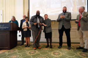 From left to right: The City of Fredericksburg’s Victoria Matthews, UMW Professor of Geography Steve Hanna, UMW Professor of Historic Preservation Christine Henry, UMW James Farmer Multicultural Center Assistant Director Chris Williams, Fredericksburg Mayor Mary Katherine Greenlaw, City of Fredericksburg Vice Mayor Charlie Frye Jr. and U.S. Sen. Tim Kaine clap toward the end of yesterday’s unveiling event for the City of Fredericksburg’s new Civil Rights Trail, "Freedom, A Work in Progress." Matthews and Williams spearheaded the project to bring to light a comprehensive history of the struggle for social justice in Fredericksburg. Photo by Suzanne Carr Rossi.