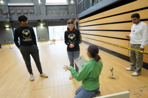 Kapil Kulkarni (left) and Lily Jacoby (right) receive feedback on their entry at last weekend's regional competition. Photo by Suzanne Carr Rossi.