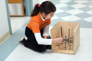 Malika Burkhanova, a sixth-grader from Pinnacle Academy in Chantilly, Virginia, prepares for the evaluation of her entry in the 'Sounds of Music' category. Photo by Suzanne Carr Rossi.