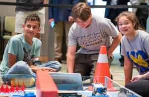 Members of the King George High School robotics team eye the clock as their time runs out during the Innovation Challenge @ Dahlgren. The Foxes fielded three separate teams during the event that took place in April 2022 at the University of Mary Washington Dahlgren Campus. (U.S. Navy photo/Released)