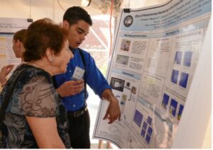 Rodgers chats with one of her Mary Washington beneficiaries, Orlando Stewart Jr. As an undergrad, Stewart, who earned a bachelor's degree in chemistry from UMW in 2015, studied the role of sunlight in breaking down oil from a 2010 spill in the Gulf of Mexico.