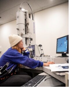 Student Kristine Dadufelza works in UMW's Jepson Science Center with the electron microscope gifted to the University by Irene Piscopo Rodgers.