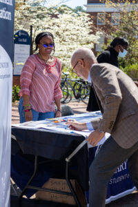 UMW President Troy Paino signs the 'Accountability' banner on the first day of last year's ASPIRE Week, as Mary Washington student Martina Pugh looks on. Photo by Sam Cahill.