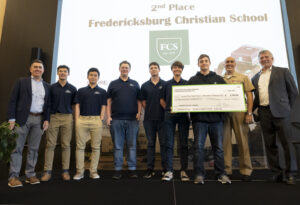 Naval Surface Warfare Center Dahlgren Division’s Technical Director Dale Sisson Jr., SES, and Commanding Officer Capt. Philip Mlynarski along with University of Mary Washington’s Dr. John Burrow (left) pose with the Fredericksburg Christian School (FCS) robotics team. The FCS team placed second in this year’s High School Innovation Challenge @ Dahlgren competition.