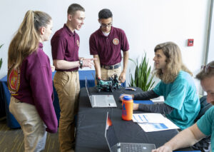 Naval Surface Warfare Center Dahlgren Division computer scientist Lucas Durham checks over the coding produced by the Mountain View High School robotics team after they competed in the second annual High School Innovation Challenge @ Dahlgren. (U.S. Navy photo/Released)