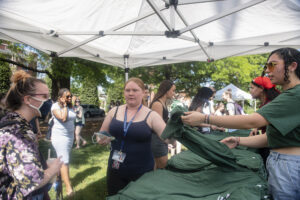 Students flocked to give-aways like these T-shirts, plus enamel pins, window clings and water bottles, at Devil-Goat Day. Photo by Tom Rothenberg.