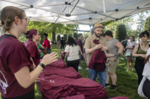Students flocked to give-aways like these T-shirts, plus enamel pins, window clings and water bottles, at Devil-Goat Day. Photo by Tom Rothenberg.