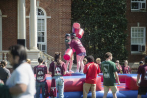 Devils, who graduate in odd years, and Goats, who graduate in even years competed in competitions like this jousting challenge during Devil-Goat Day. Photo by Tom Rothenberg.