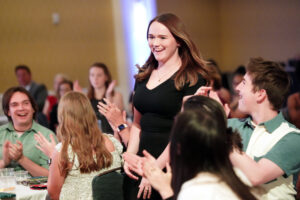 Surrounded by fanfare from her classmates, Audrey Flavin walks to the stage after learning she's won the Cedric Rucker Eagle Beyond Compare Award. Photo by Suzanne Carr Rossi.