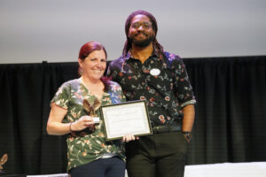 Student Activities and Engagement Assistant Director Michael Middleton presented the Gwen Hale Giving Tree Award to College of Education Director of Clinical Experiences and Partnerships Kristina Peck. Middleton received the award last year. Photo by Suzanne Carr Rossi.
