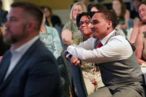 Seniors Maya Jenkins (left) and Cameron Washington listen while their classmates are honored for their outstanding contributions to the UMW community during the 2023 Eagle Awards ceremony. Photo by Suzanne Carr Rossi.