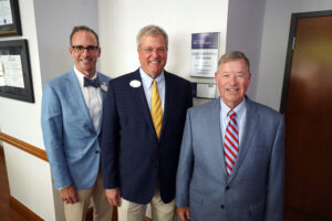 From left: Rob Strassheim '96, COB Interim Dean Ken Machande '94 and Professor Emeritus of Business Law and Taxation Leigh Frackelton in front of the classroom. Photo by Suzanne Carr Rossi.