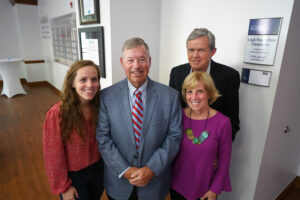 The University of Mary Washington dedicated the Leigh Frackelton Classroom on April 20 in honor of Professor Emeritus Leigh Frackelton (center) and the Gibbons Team Room, thanks to a generous gift from Bill, Susie and Michelle Gibbons '16. Both spaces are in Woodard Hall, home of UMW's College of Business. Photo by Suzanne Carr Rossi. 