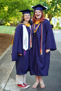 Megan Sullivan (left) received a master's degree in elementary education and Sara Roberts received a bachelor's degree in psychology during the University of Mary Washington's 112th Commencement ceremony. Photo by Suzanne Carr Rossi.