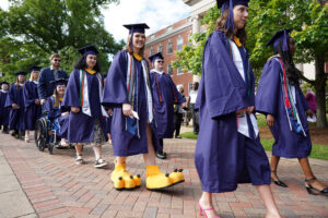 Soon-to-be UMW grads, including Mariana Haugh, who often wore the Eagles mascot uniform of Sammy D. Eagle, process toward Ball Circle. Photo by Suzanne Carr Rossi.