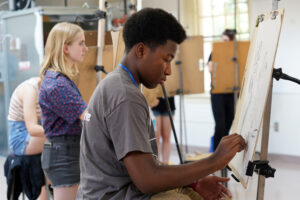 Alfred-David Viyuoh (foreground) and Vivian Rinko complete charcoal sketches during "Exploring Art and Practice." The course was among several offered during the Summer Enrichment Program, which had students taking off-campus excursions, sleeping in a residence hall and dining at the Cedric Rucker University Center. Photo by Suzanne Carr Rossi.