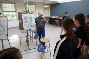Assistant Professor of Painting and Drawing Ashe Laughlin asks for student opinions on a still life charcoal drawing assignment for his course, "Exploring Art and Practice." Participants got a glimpse of the artistic process and learned about sketching and painting during the session, part of the Summer Enrichment Program. Photo by Suzanne Carr Rossi.