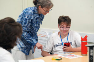 Assistant Professor of Writing Studies and Digital Studies Brenta Blevins talks with high-schooler Chris Shortridge about augmented reality during the 2023 Summer Enhancement Program, designed to introduce upcoming college students to campus life. Photo by Suzanne Carr Rossi.