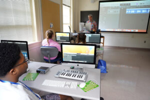 Bryce Brookebank (back row) listens as Adjunct Instructor of Music Michael Bratt teaches "Audio Technology and Production" during UMW's Summer Enrichment Program. The six-day event brought high-schoolers to campus for an introduction to college life. Photo by Suzanne Carr Rossi.