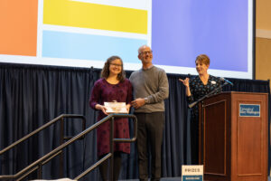 Simpson Library Head of Special Collections and Digital Scholarship Angie Kemp (right) receives the Hurley Award for exceptionally meritorious service and character. She's congratulated by UMW President Troy Paino and Executive Director of Human Resources Beth Williams. Photo by Sam Cahill. 