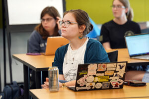 UMW junior Savannah Sinor listens as Olsen shares stories of her time with the Peace Corps. An international affairs and French major, Sinor hopes to land a spot with the Peace Corps, as well. Photo by Suzanne Carr Rossi