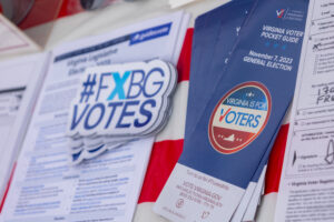 Student representatives from UMW Votes and Day on Democracy handed out stickers and information to help voters navigate the polls. Photo by Sam Cahill.