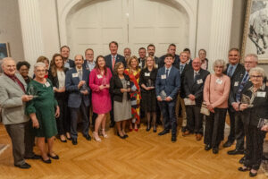 UMW alumna Meghan McLees '23 won this year's Outstanding Young Volunteer Award from the Virginia governor's office. She poses here (front row, pink dress) in a group shot from last night's award ceremony at the Governor's Mansion in Richmond. Official Photo by Christian Martinez, Office of Governor Glenn Youngkin.