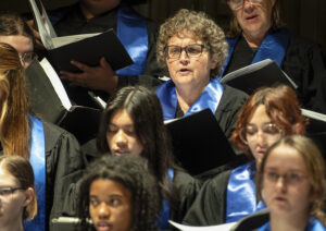 Professor of Chemistry and UMW Honors Program Director Kelli Slunt (top) performs during the Nov. 7 rehearsal for Sunday's 'Two Roads Diverged: Fall Choral Concert.' Photo by Tom Rothenberg.