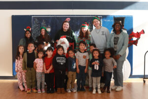 Back row, from left to right, UMW students Kushi Constance, Jillian Vargas, Sarah Hybl, Ainsley Lord and Knox McKinley, along with Mary Wash alumna Tamara Garrett '23 pose with a group of children from Fredericksburg City Public Schools Preschool Program. Photo by Karen Pearlman.