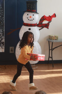 UMW international relations major Jillian Vargas was among several current and former COAR members who visited schools in Fredericksburg and Stafford to drop off gift boxes. The students worked for months to fill the boxes with toothbrushes, crayons, toys and more. Photo by Karen Pearlman.