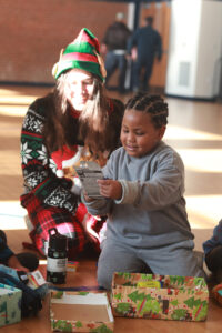 UMW international relations major Jillian Vargas was among several current and former COAR members who visited schools in Fredericksburg and Stafford to drop off gift boxes. The students worked for months to fill the boxes with toothbrushes, crayons, toys and more. Photo by Karen Pearlman.