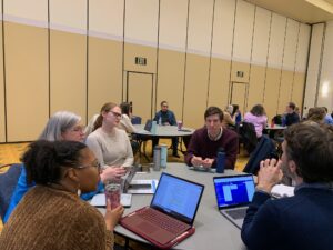 Faculty and staff, including Center for Teaching Director Victoria Russell (second from left), who led the effort to host Cavanagh's presentation, discuss classroom challenges.